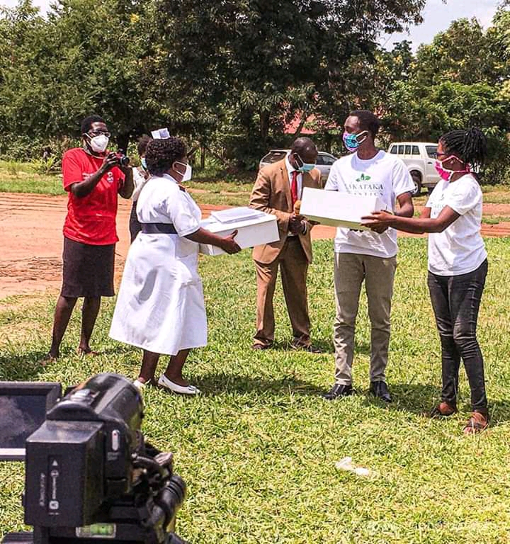 Caroline and another volunteer distribute handmade masks to officials at the Lira Regional Hospital